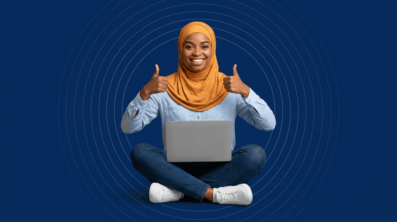 Happy student with laptop giving thumbs up